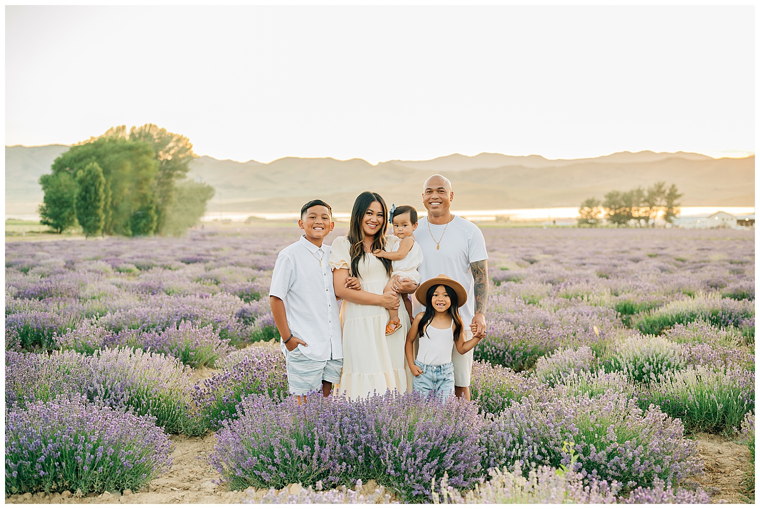 Photo of a family of 5 standing in the lavendar fields. 