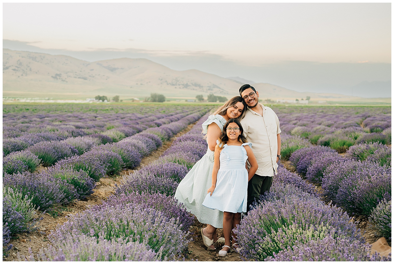 A family standing in the middle of the mona lavender fields. 
